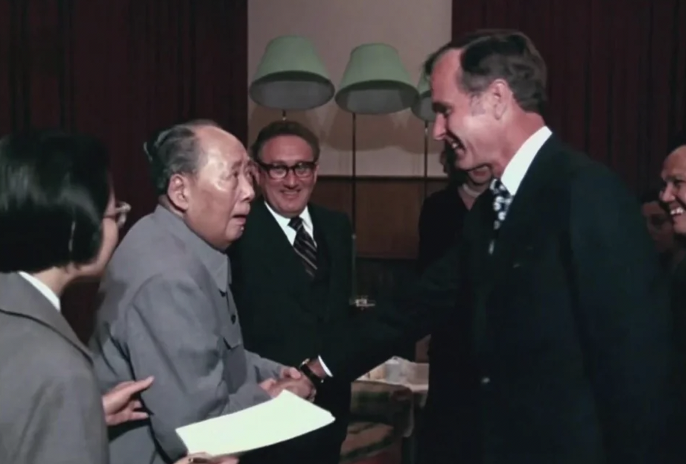 Chinese dictator Mao Zedong meeting with future US president George H.W. Bush in 1975. Secretary of state Henry Kissinger can be seen in the background.