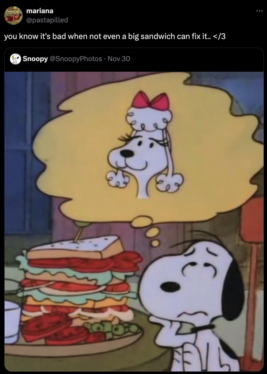 snoopy thinking of girlfriend - mariana you know it's bad when not even a big sandwich can fix it..