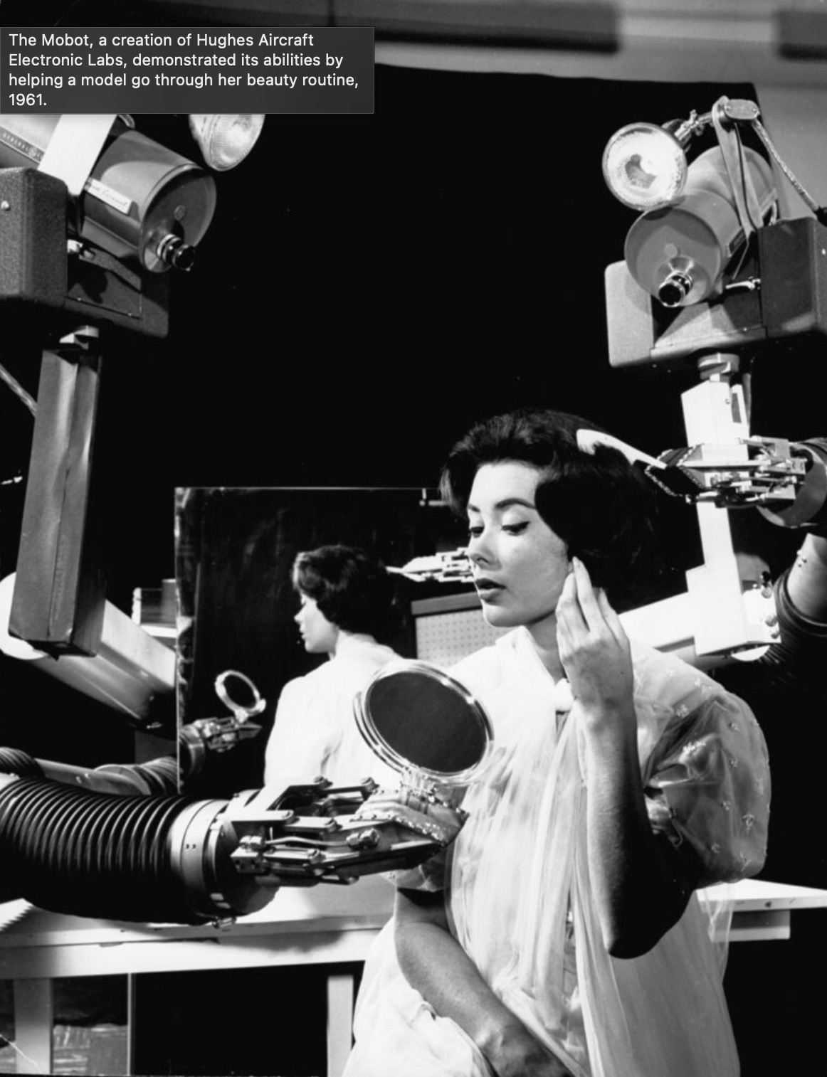 mobot hughes aircraft - The Mobot, a creation of Hughes Aircraft Electronic Labs, demonstrated its abilities by helping a model go through her beauty routine, 1961.