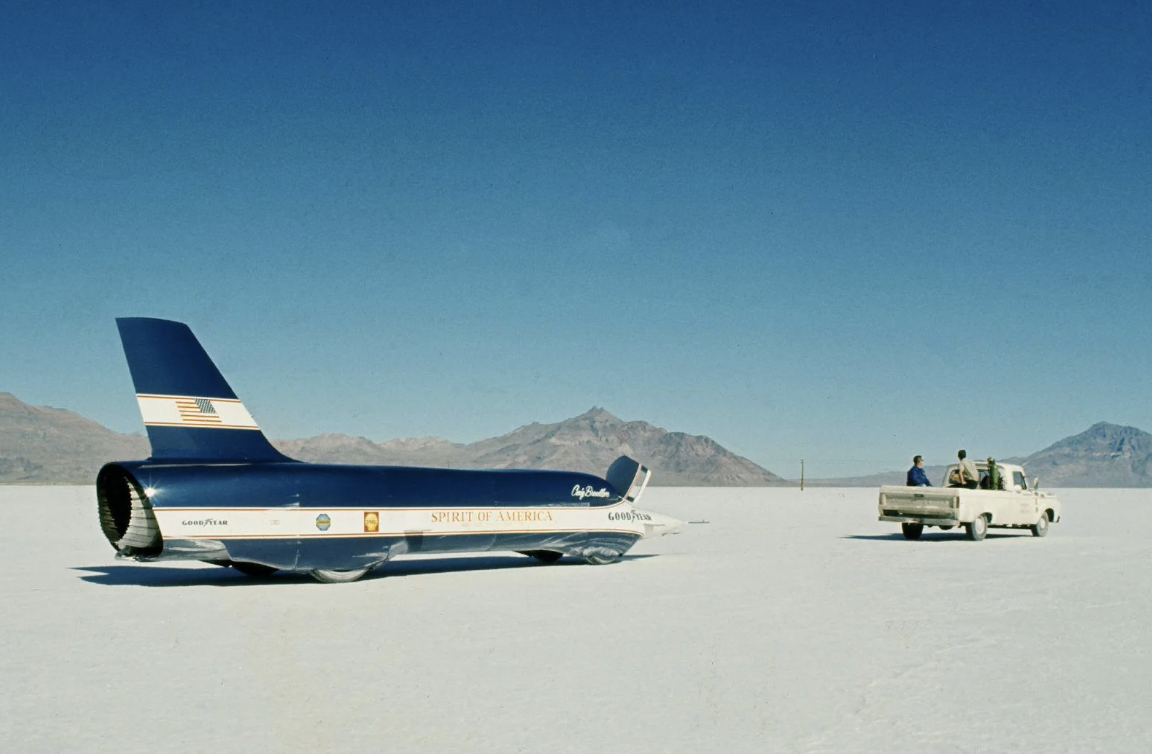 Craig Breedlove and "Spirit of America – Sonic 1" after new land speed record, Utah, 1965. He made passes at 555 mph, and later over 600 mph. Breedlove was the first man over 500 mph, and set five land speed records. 