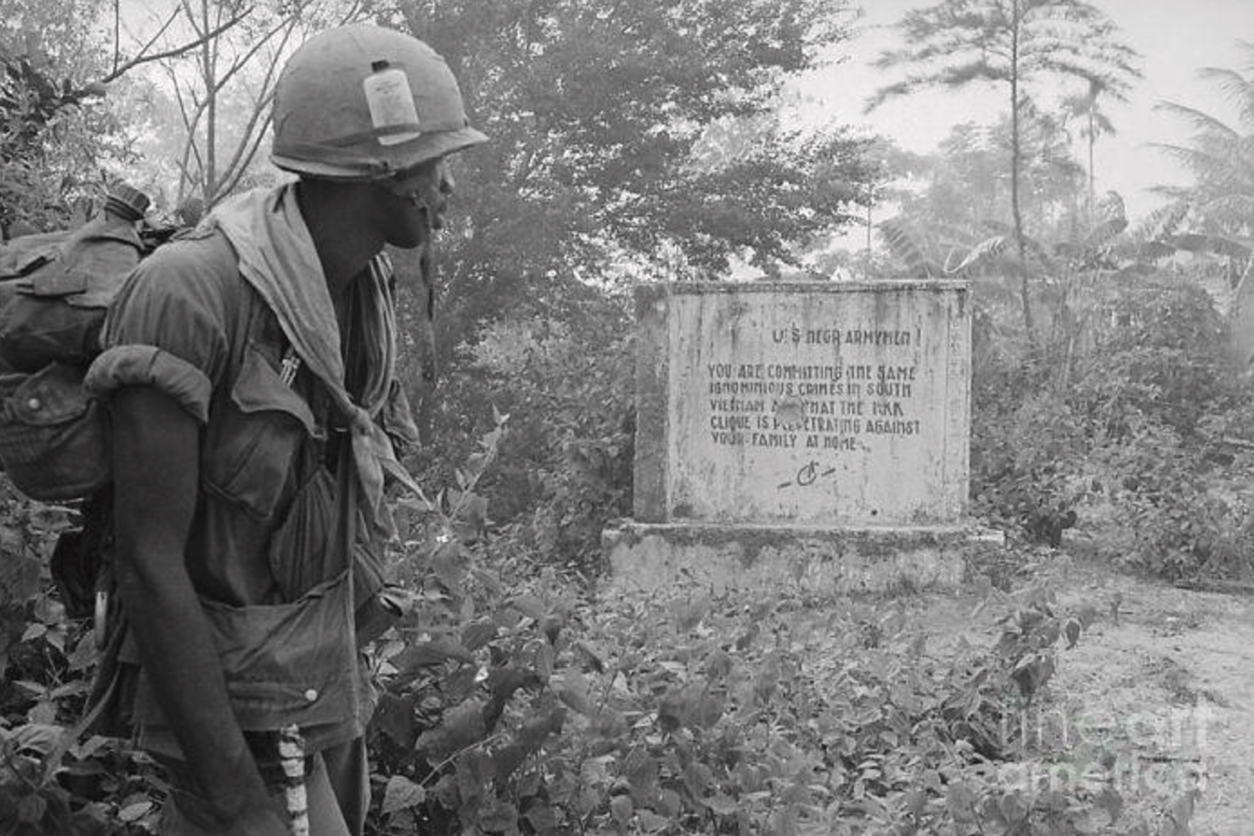 A black U.S. soldier reads a message left by the Việt Cộng during the Vietnam War. The message reads, "U.S. [Black] Armymen, You Are Committing The Same Ignominious Crimes In South Vietnam That The KKK Clique Is Perpetrating Against Your Family At Home." 1970.