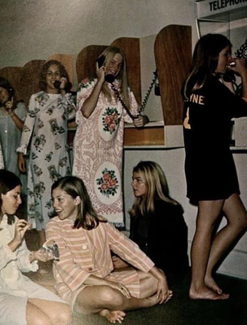 Students in a girls’ dorm lining up to make phone calls. 