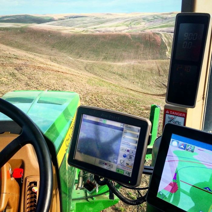 The high-tech cab of a John Deere tractor.