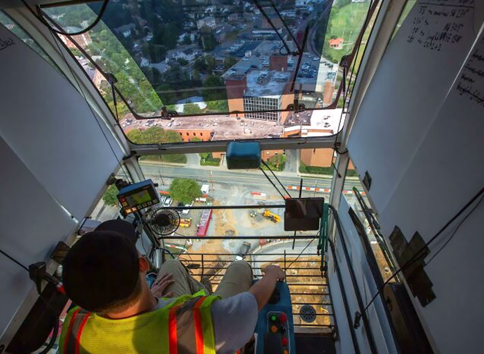 The operator cab of a tower crane soaring at 240 feet above the ground.