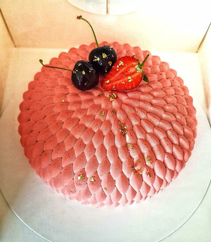 A cherry and strawberry cake that looks like a dream cloud.