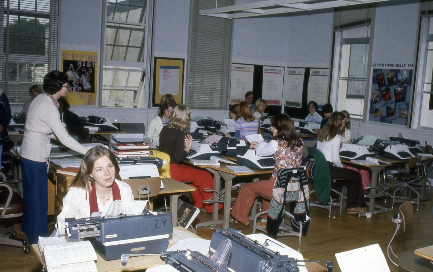 Typing class with manual and electric typewriters.