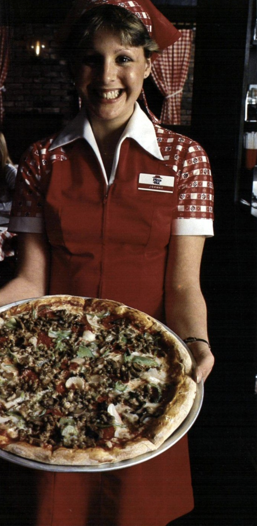 With a huge pizza, 1970s.