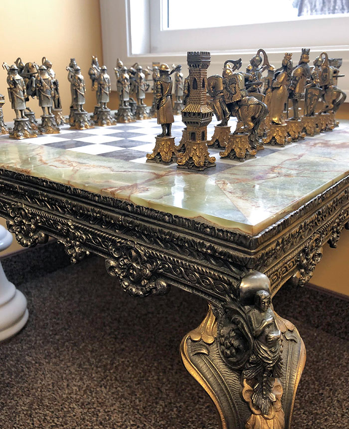 "This increible (an heavy) custom made chess table complete with stone board and metal pieces."