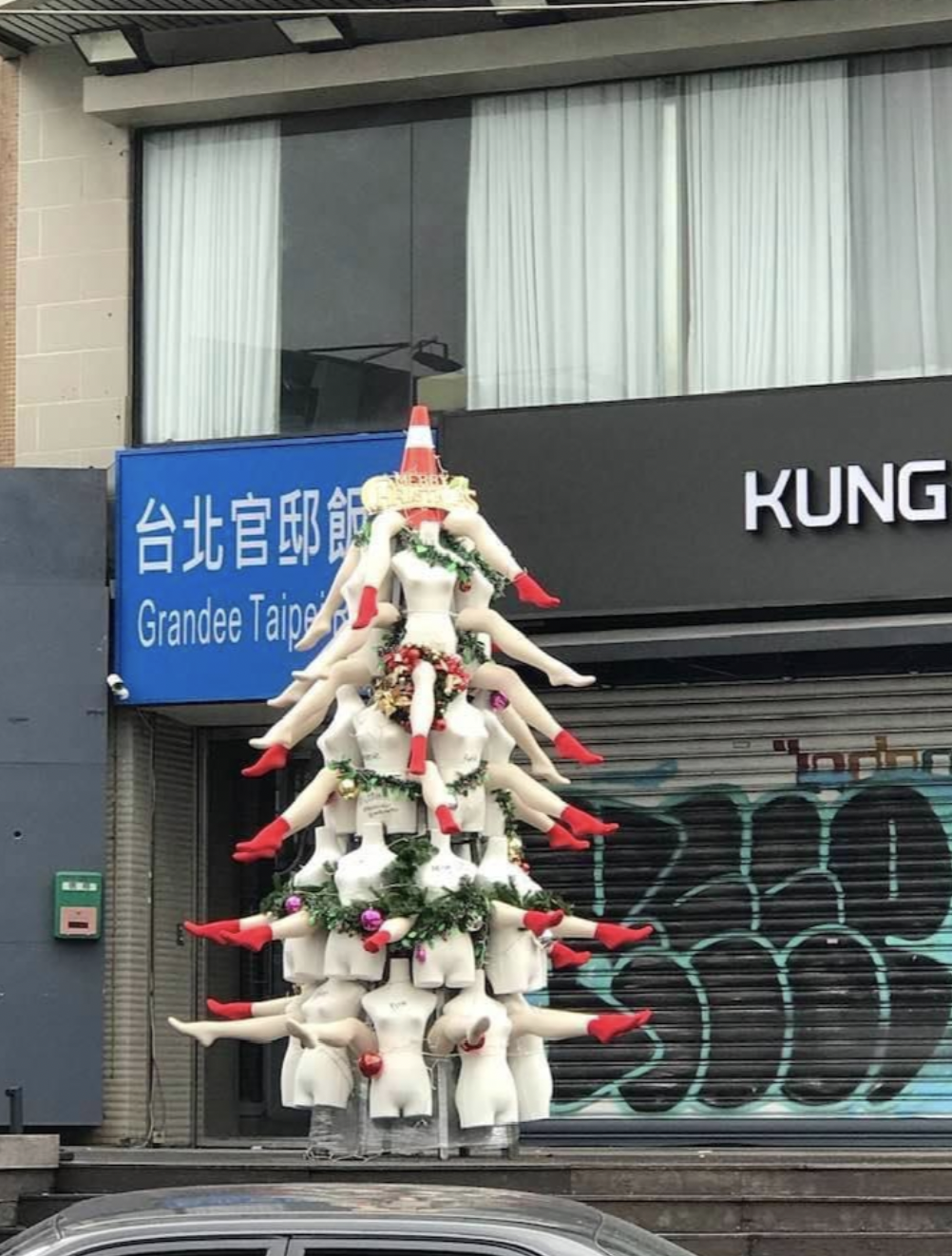 A mannequin and cone tree. 