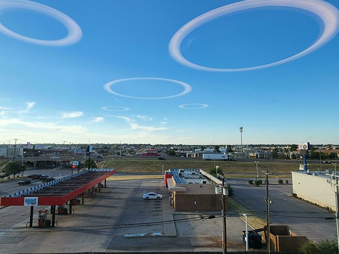 The ceiling lights look like strange circular clouds floating in the sky.