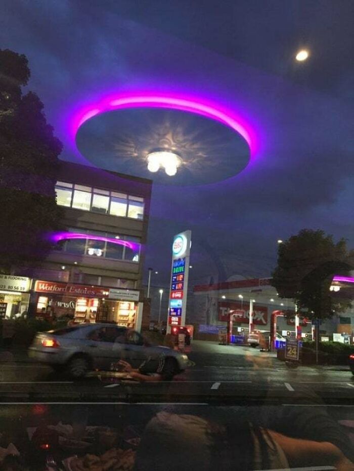 The reflection of this light makes it seem like a giant UFO is landing on the street.