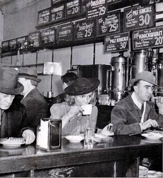 A woman sips coffee in a Chicago diner - 1940's