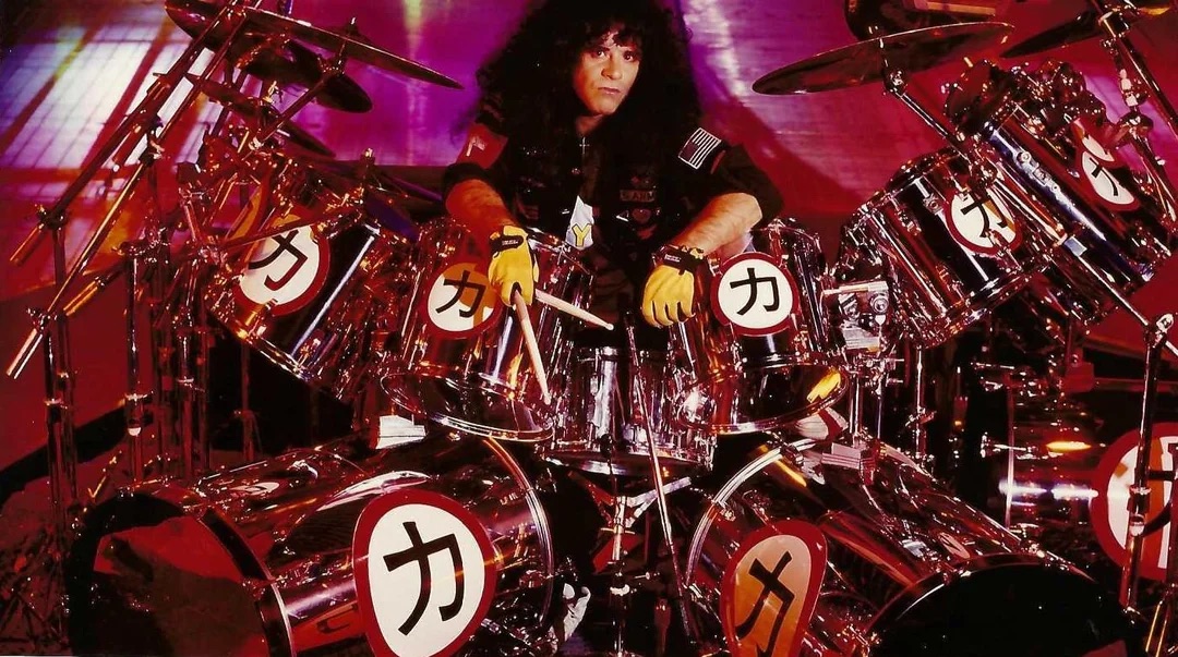 Eric Carr Poses With A Huge Drum Kit