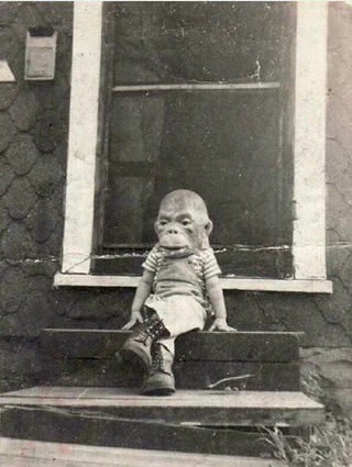 A kid in a monkey mask from the 1920s.