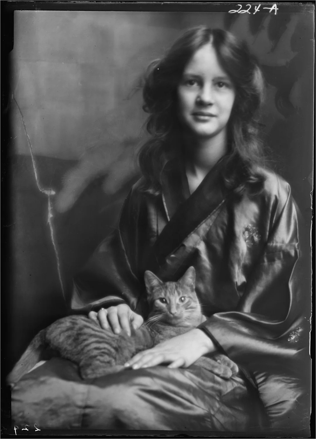 A vintage studio portrait of girl a with cat - 1913