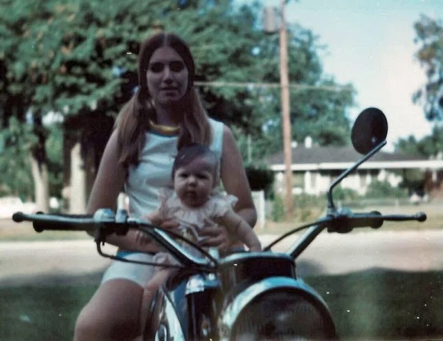 A mom and her baby on a motorcycle in 1970.