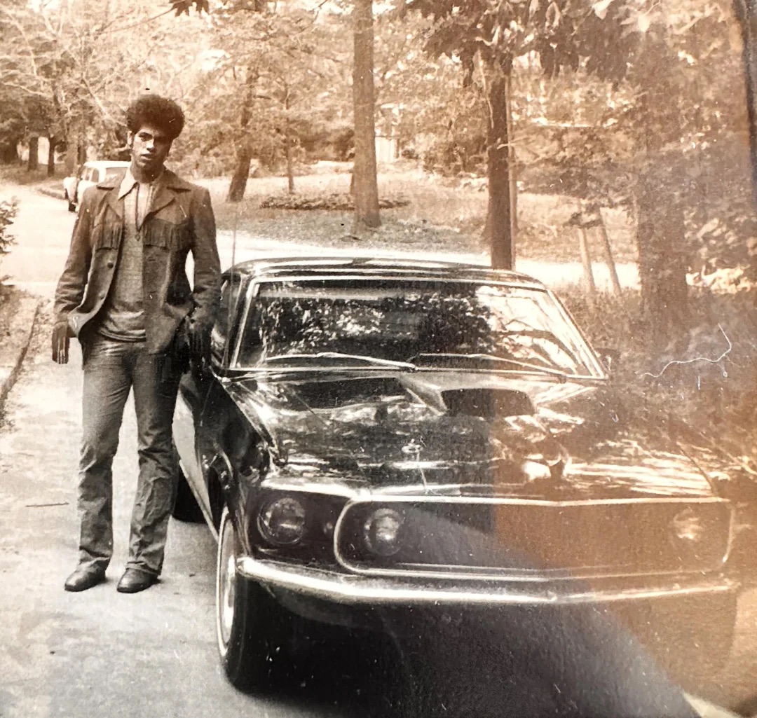 An afro and a muscle car. Welcome to 1970!