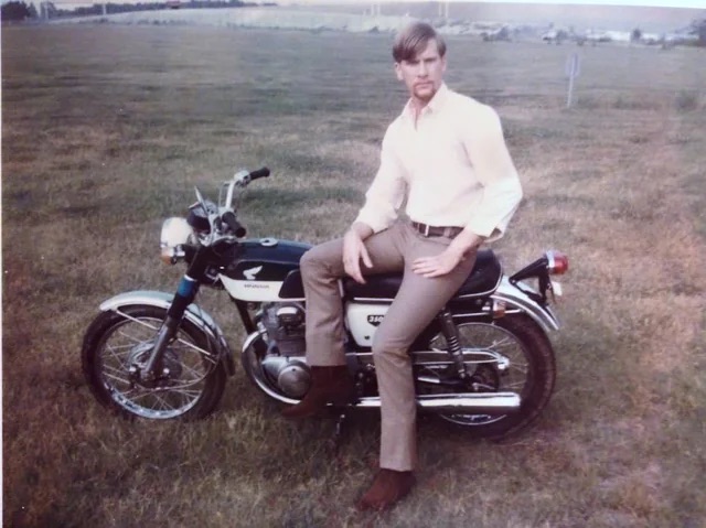  A cool cat posing with his motorcycle in 1970.