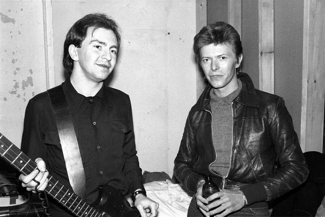 David Bowie and Devo’s Gerald Casale pose backstage - 1977