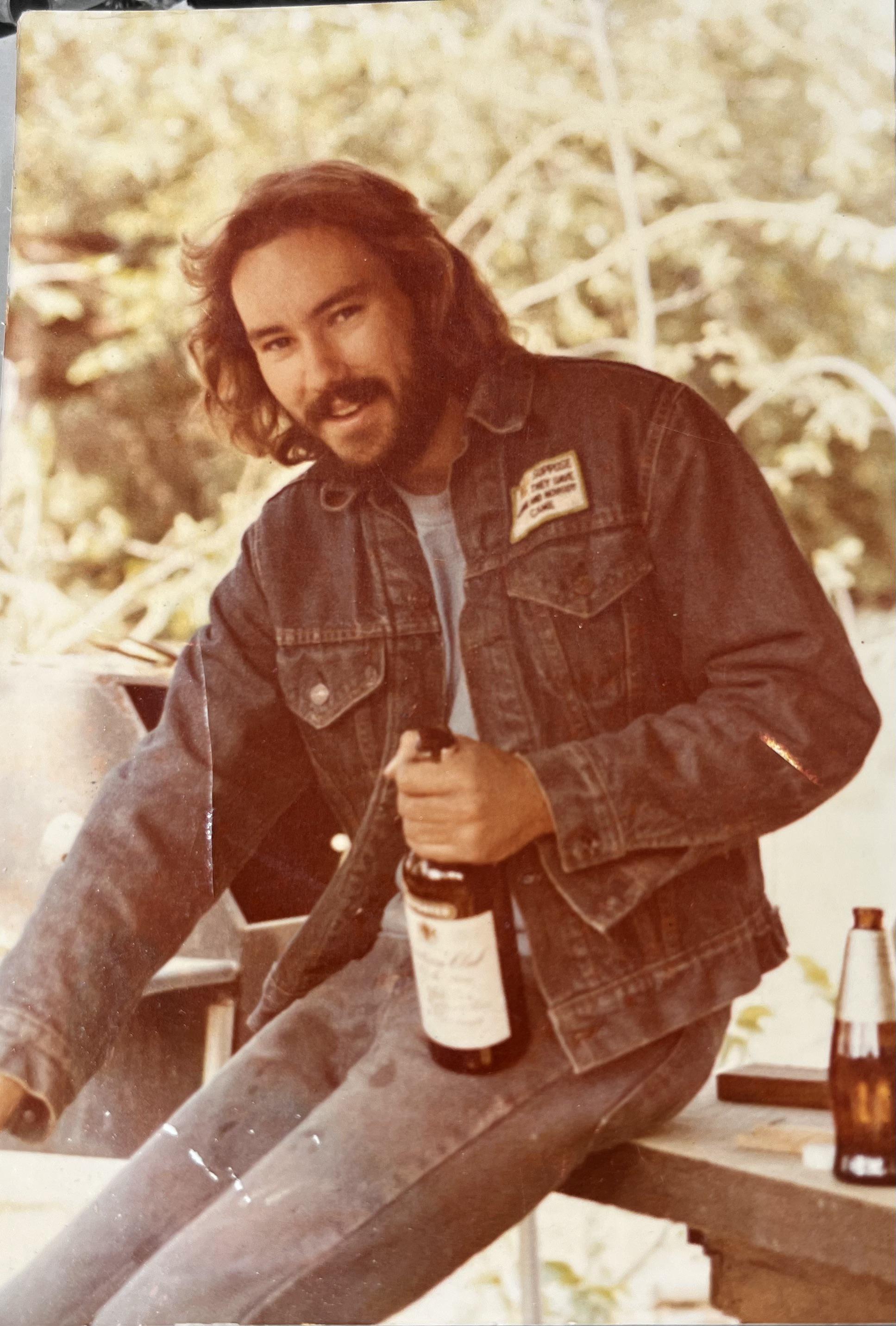 Long hair, and a bottle. Rebel style.