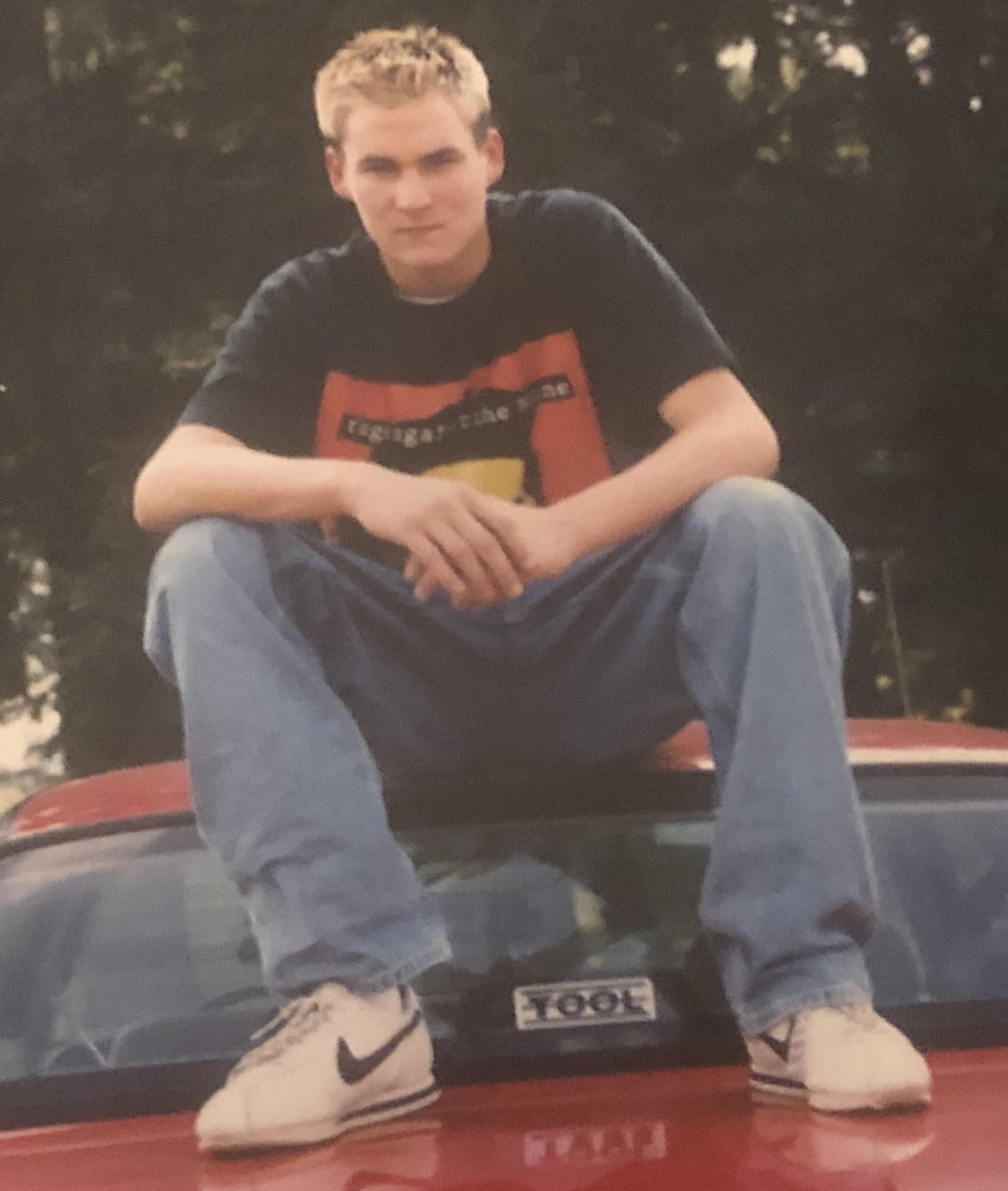 Sitting on the car as an afternoon activity.