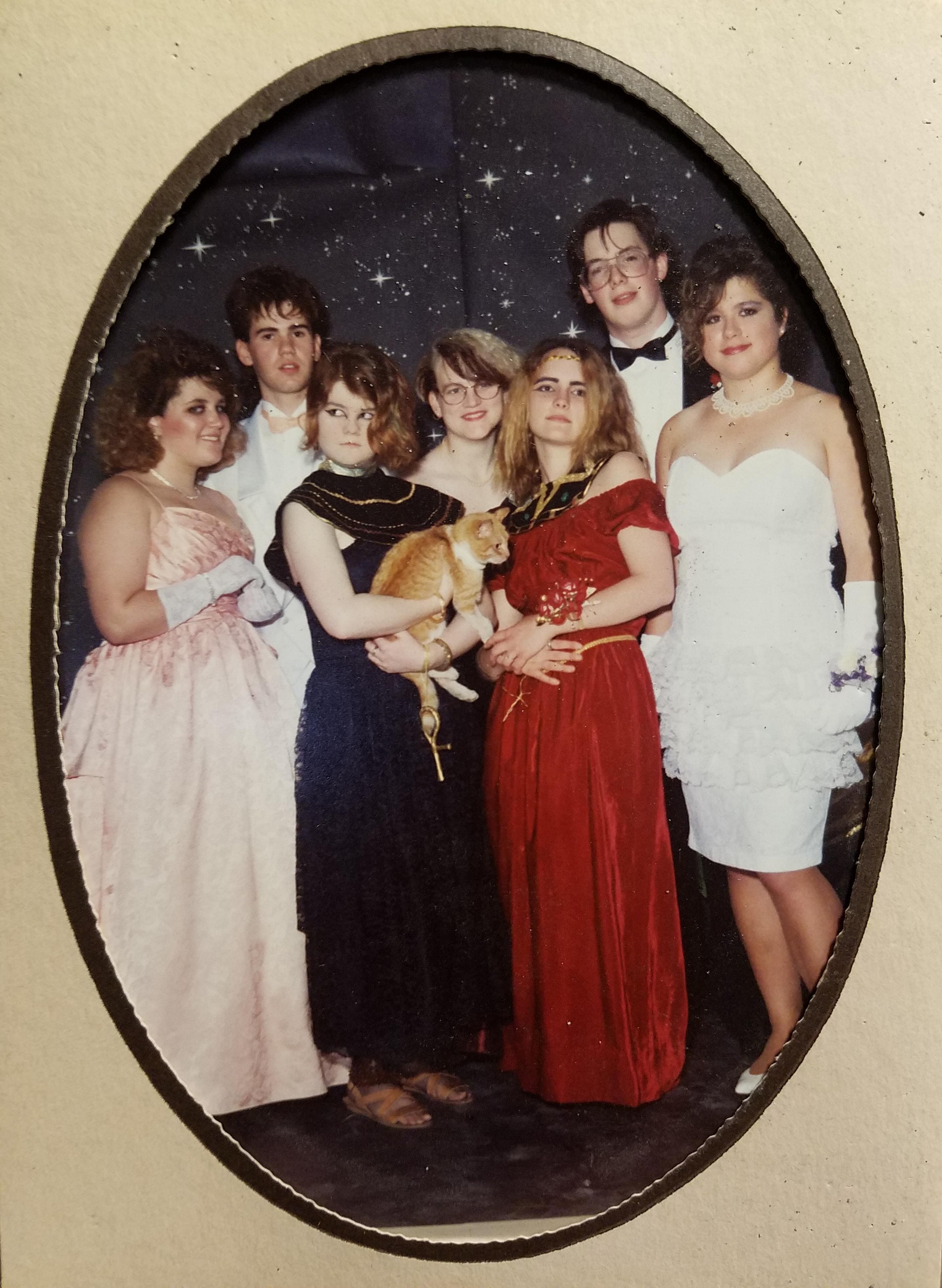 Gowns, eyeliner, and one confused feline.