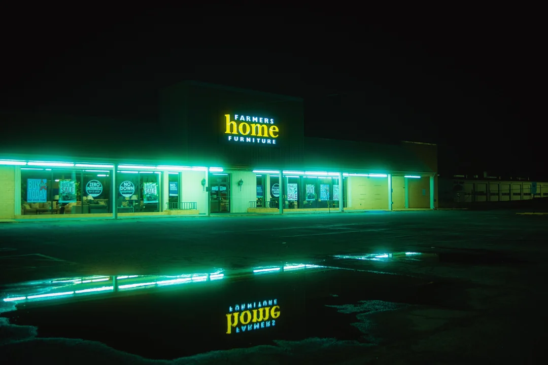 A mint-green halo reflected in puddles.