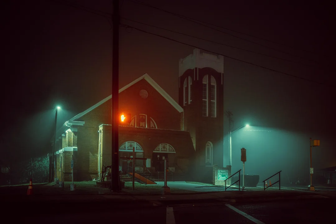 Shadows cling to the wall and a song's hear in the distance.