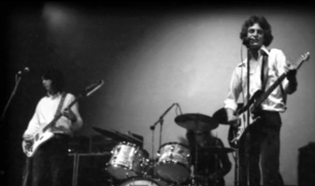 Big Star delivering their shimmering power pop with raw energy on stage.