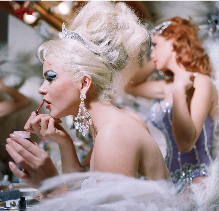 Showgirls backstage, turning rhinestones and red lipstick into the city’s ultimate destination..