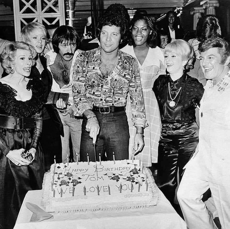 Tom Jones celebrates in true Vegas style, surrounded by stars, sequins, and plenty of champagne.