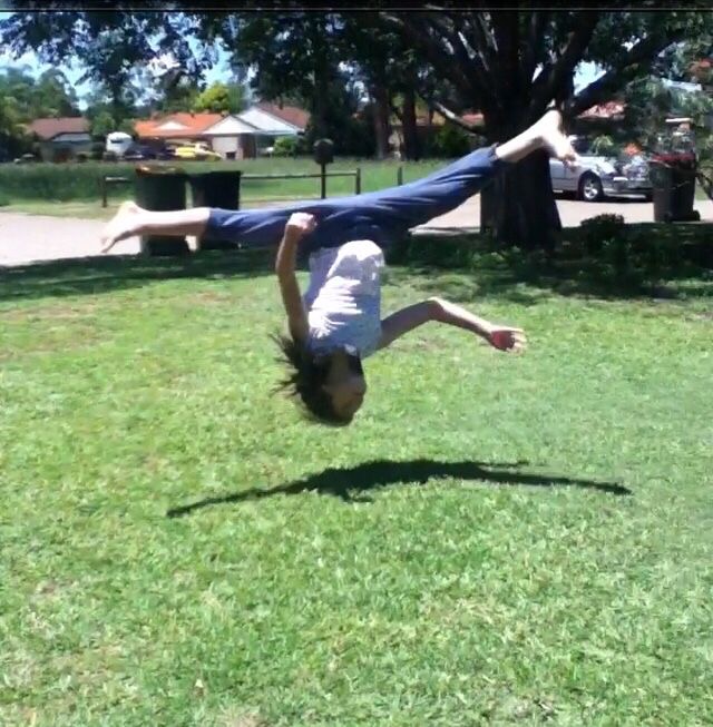 Girl About to Kiss the Earth With Her Skull
