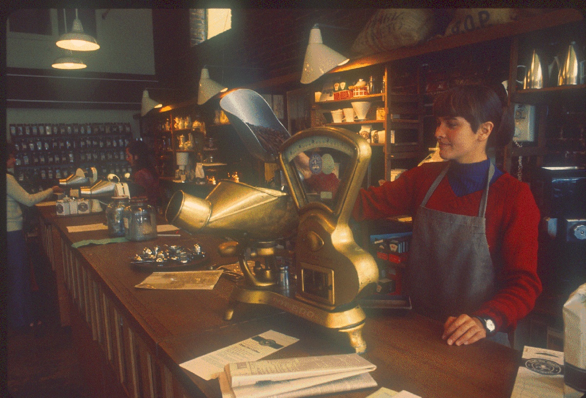 The original Starbucks at Pike Place Market quickly became a gathering spot, with its now-iconic sign promising Coffee, Tea, and Spices.