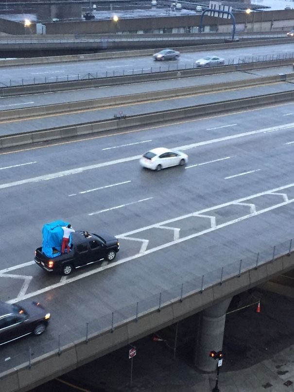 Guy on the Roof... of a Car... Holding a Thing