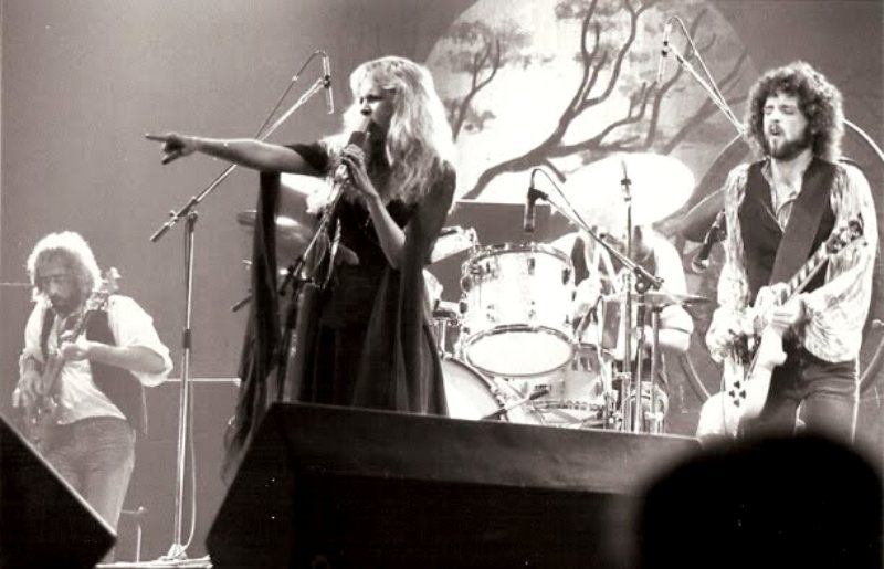 Stevie Nicks points out into the crowd, commanding the stage as Fleetwood Mac’s sound and presence filled arenas during the Rumours tour.