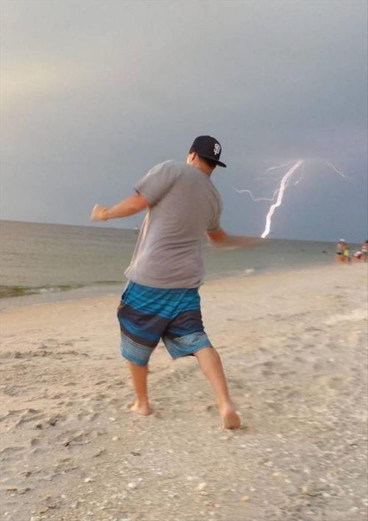 Man Casts Lightning Like a Beachside Wizard