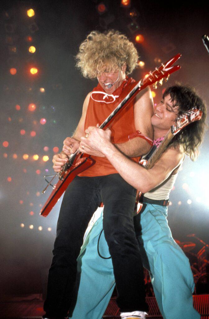 Sammy Hagar and Eddie Van Halen doing a lot of guitar hugging.