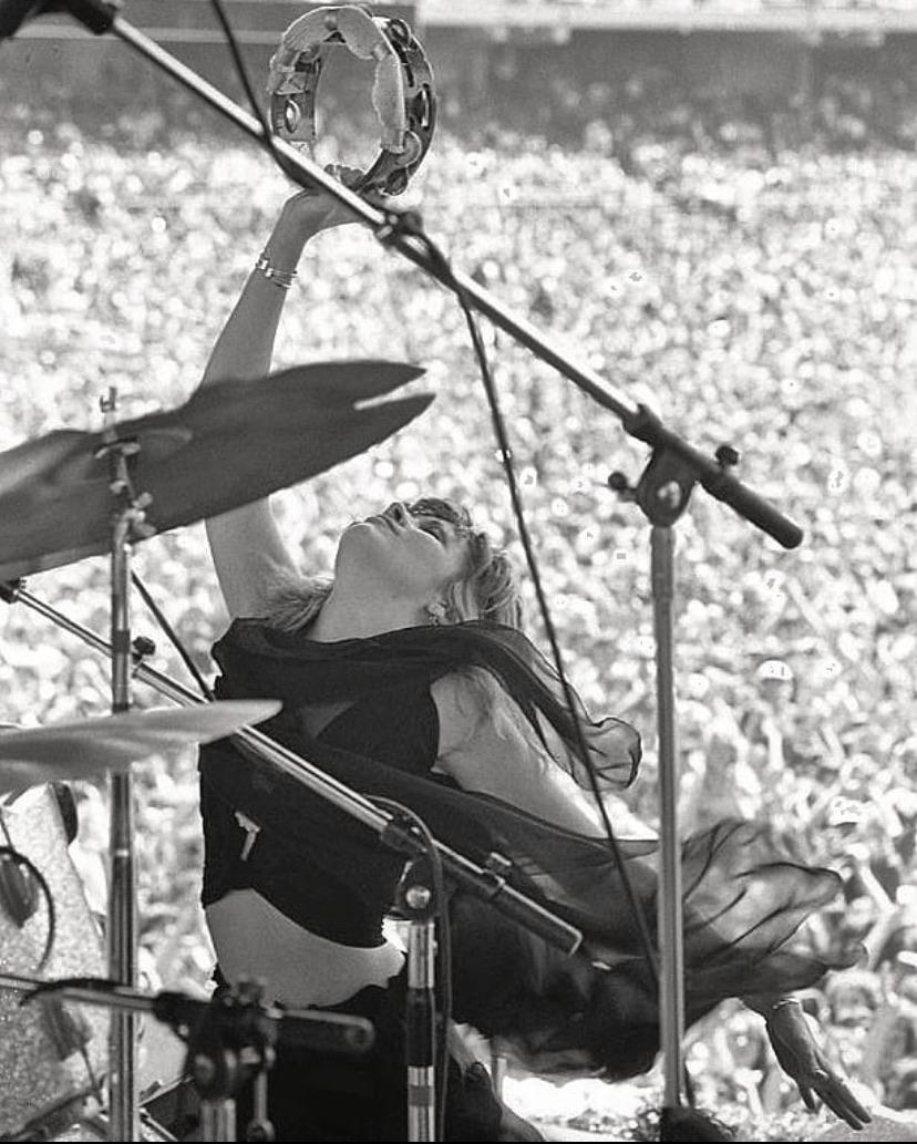 Like a priestess summoning the storm.