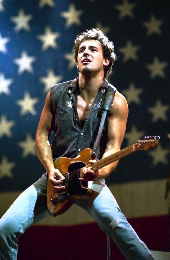 "The Boss" embodying his true rock 'n' roll form with the flag behind him.