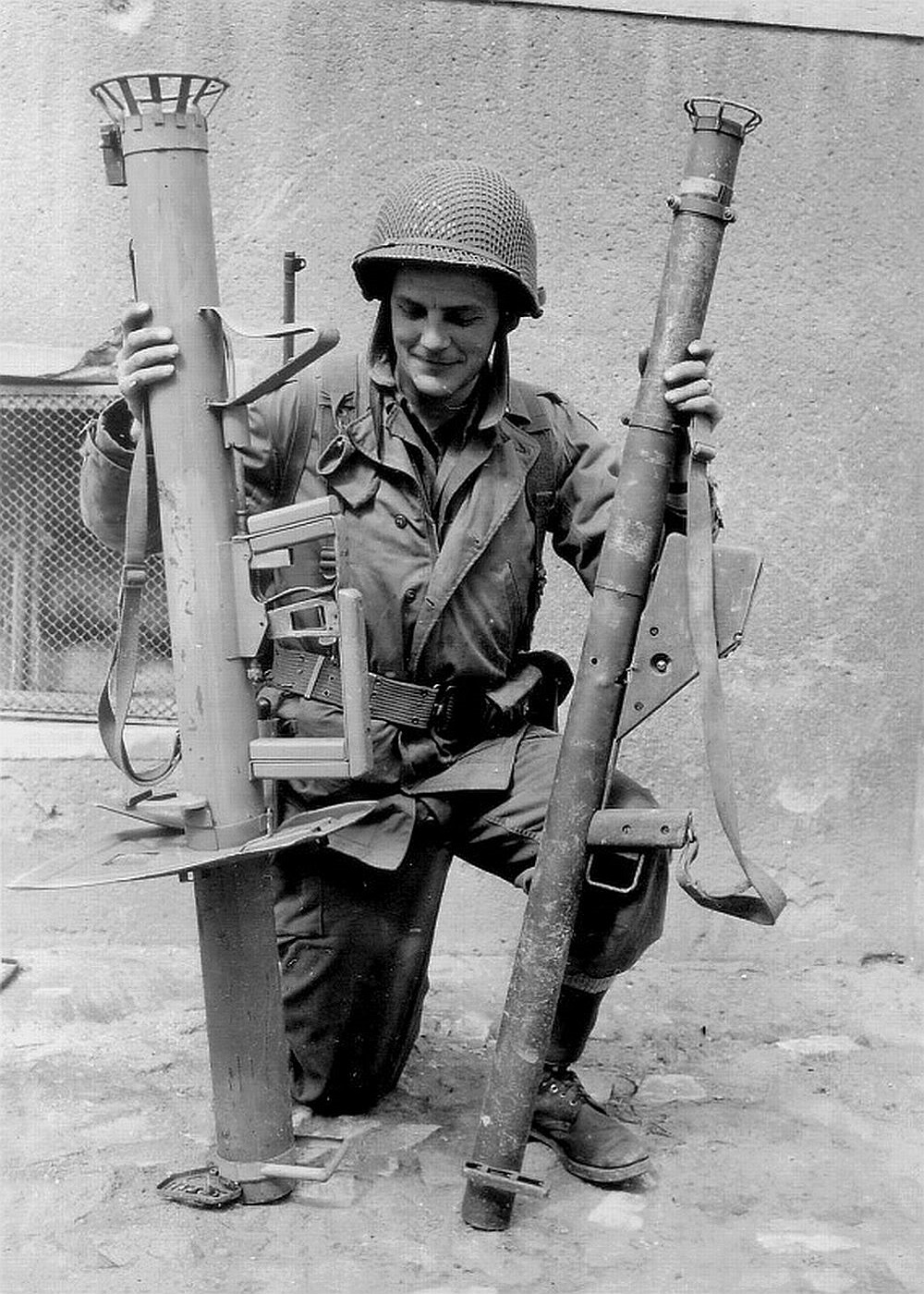 An american soldier examines German and Allied rockets.