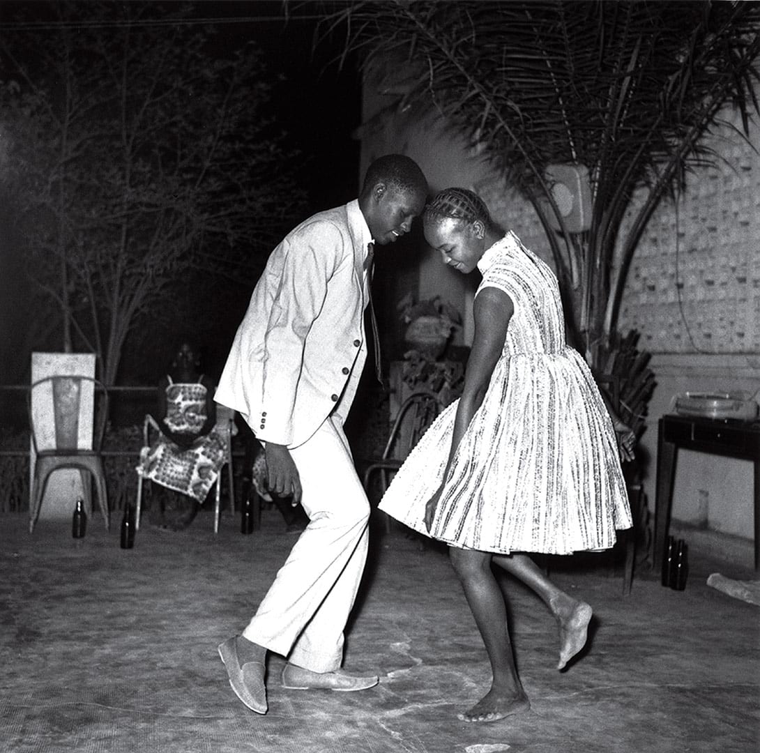 A young couple dances under the night warmth, during the 1950s.