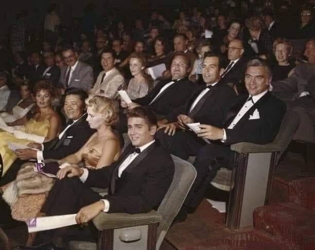 The row with the best suits in the place and the extra popcorn.