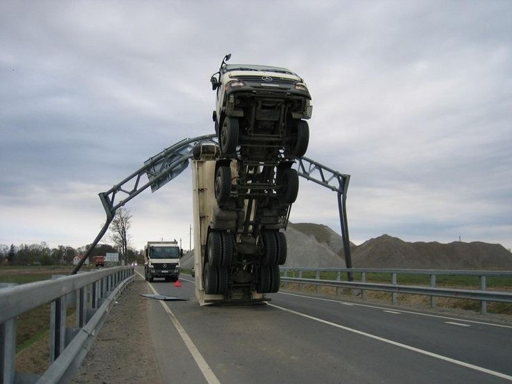 Truck hooks a road sign and lifts off like a Boeing 747