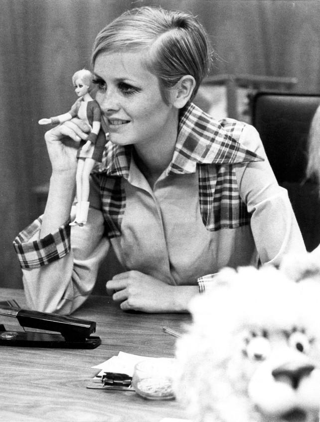 Holding her own Barbie doll.