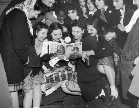 Girls Reading Magazines About Him