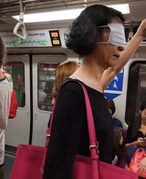 Woman Wearing Mask on Eyes in the Subway