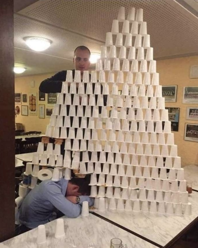 Man Sleeping at Work Becomes Cup Pyramid Exhibit