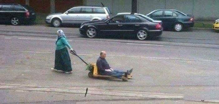 Grandma Towing Grandpa in a Cart