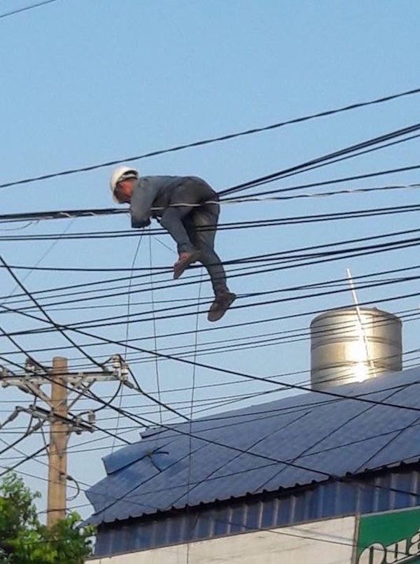 Guy Hanging from Street Wires