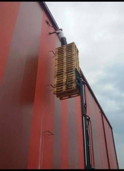 Man Painting Wall in a Dangerous Way